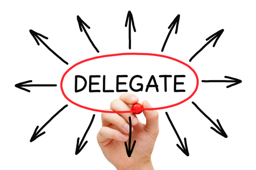 Hand drawing Delegate concept with marker on transparent wipe board isolated on white.